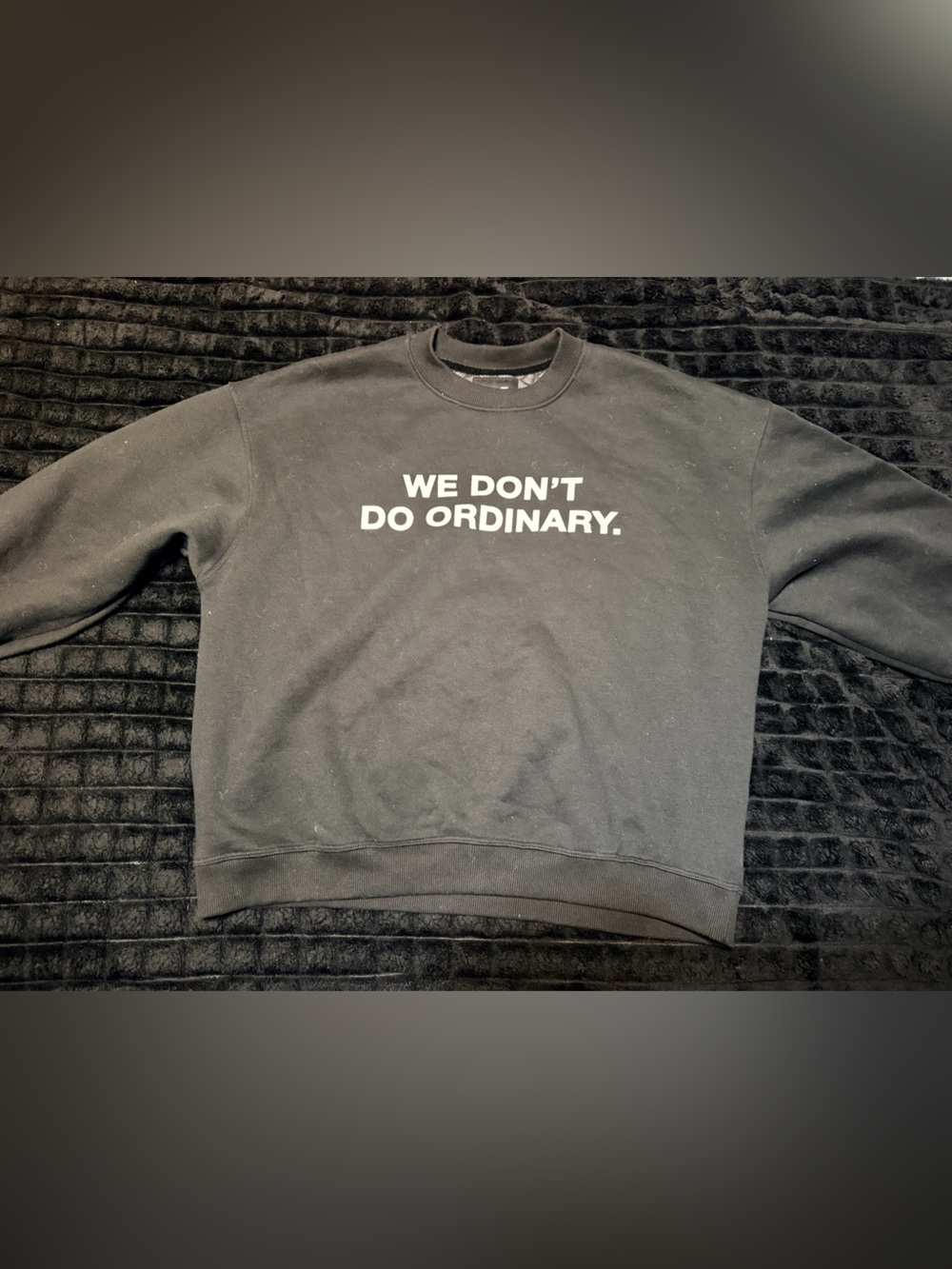 Black Crewneck Sweatshirt with "WE DON'T DO ORDINARY" Print